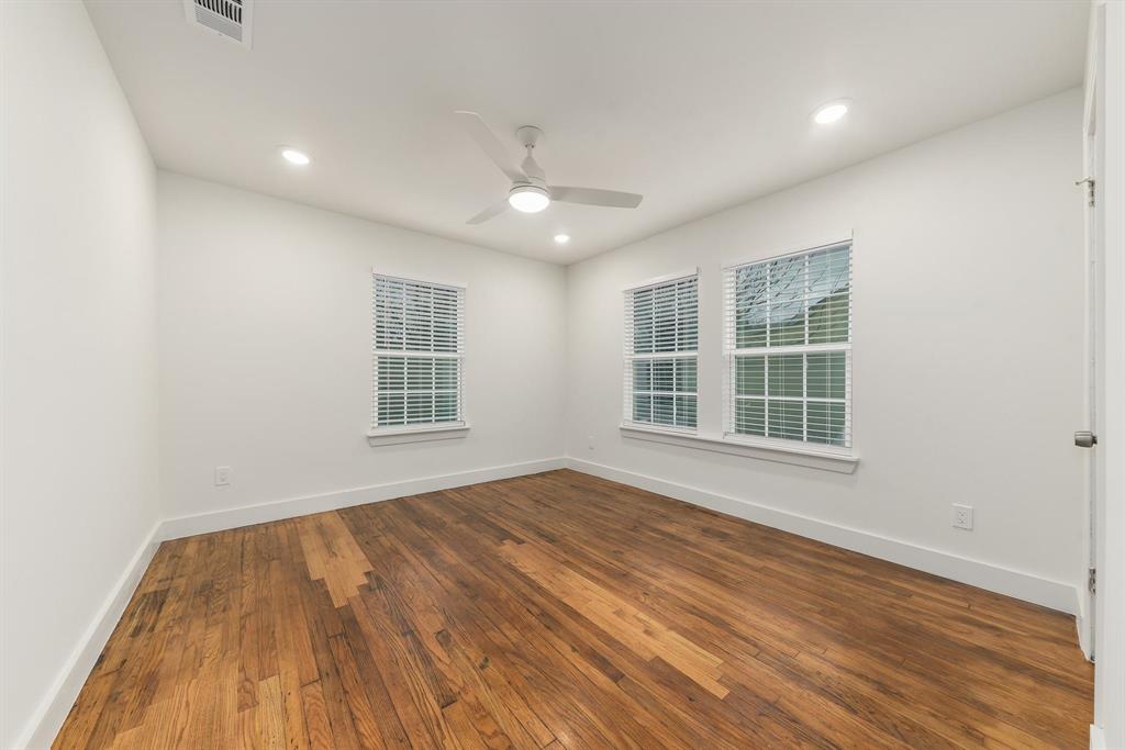 715 Dover Street Dallas, TX 75216 - Photo 7 of 8 Spacious room featuring wood-finish flooring, two windows with blinds, recessed lighting, and a ceiling fan