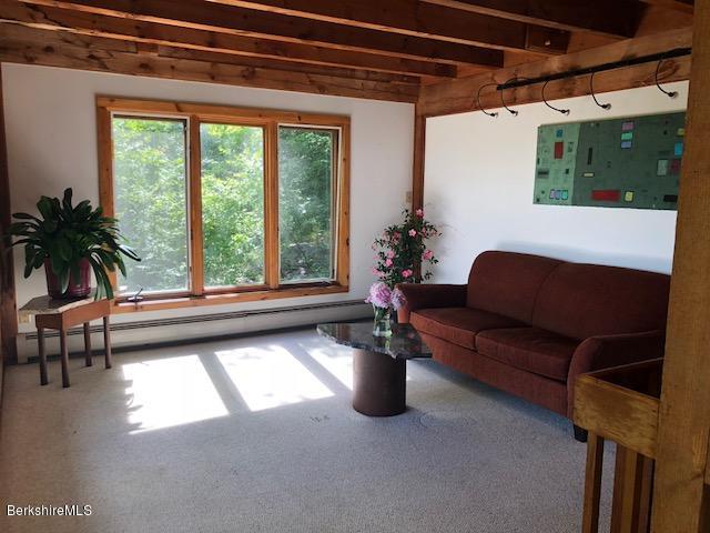 7 Noppet Road Lanesborough, MA 01237 - Photo 17 of 42 a living room with furniture and a large window