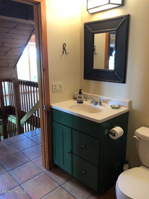 7 Noppet Road Lanesborough, MA 01237 - Photo 31 of 42 a bathroom with a toilet sink and mirror