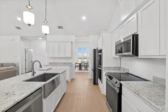 a kitchen with a sink stove and microwave