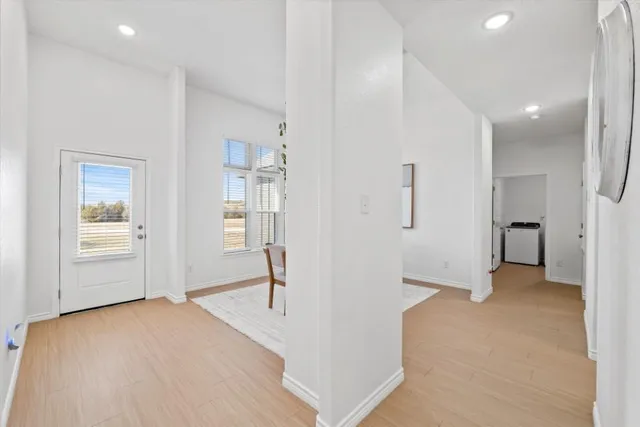 a view of empty room with wooden floor and windows