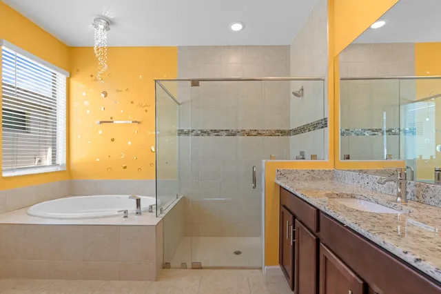 a bathroom with a granite countertop sink and a large mirror