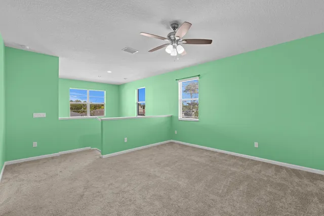 a view of room with window and ceiling fan