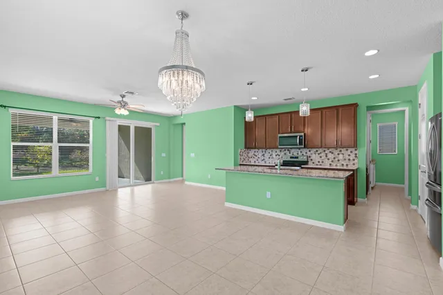 a view of kitchen and kitchen with microwave