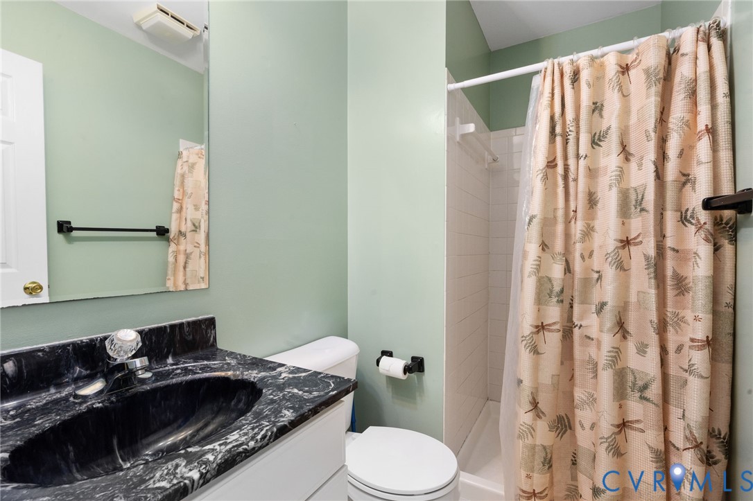 16379 Arch Hill Road Hanover, VA 23069 - Photo 13 of 26 a bathroom with a granite countertop sink and a mirror