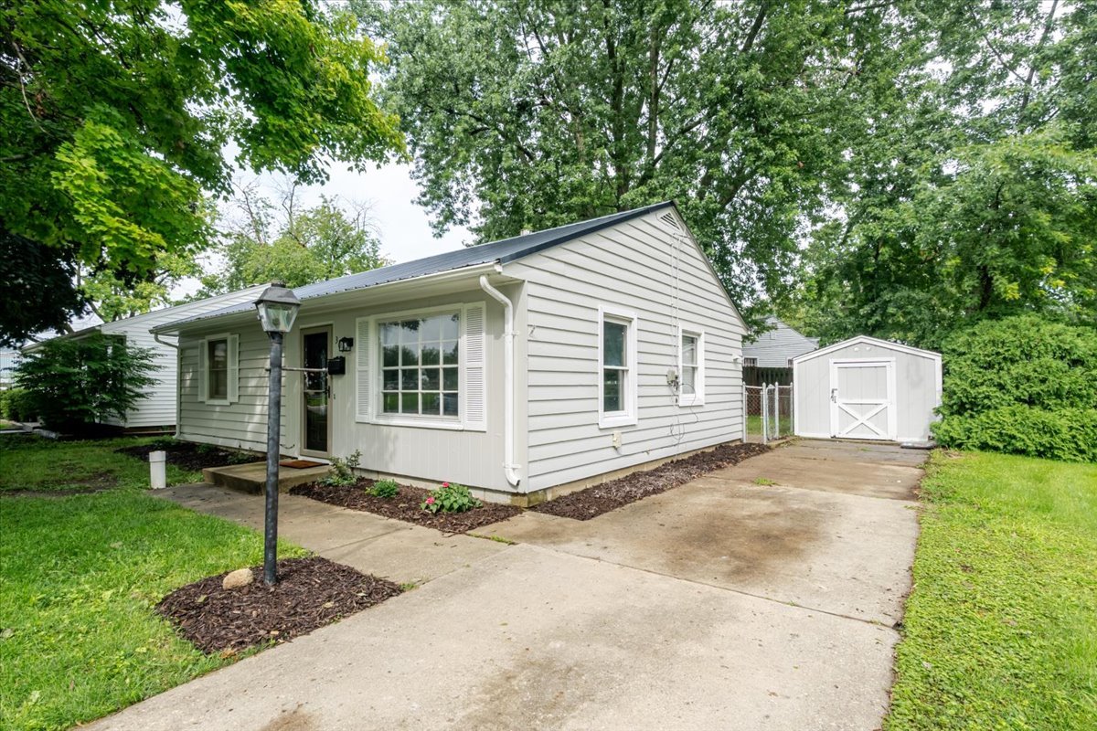a front view of a house with a yard and porch