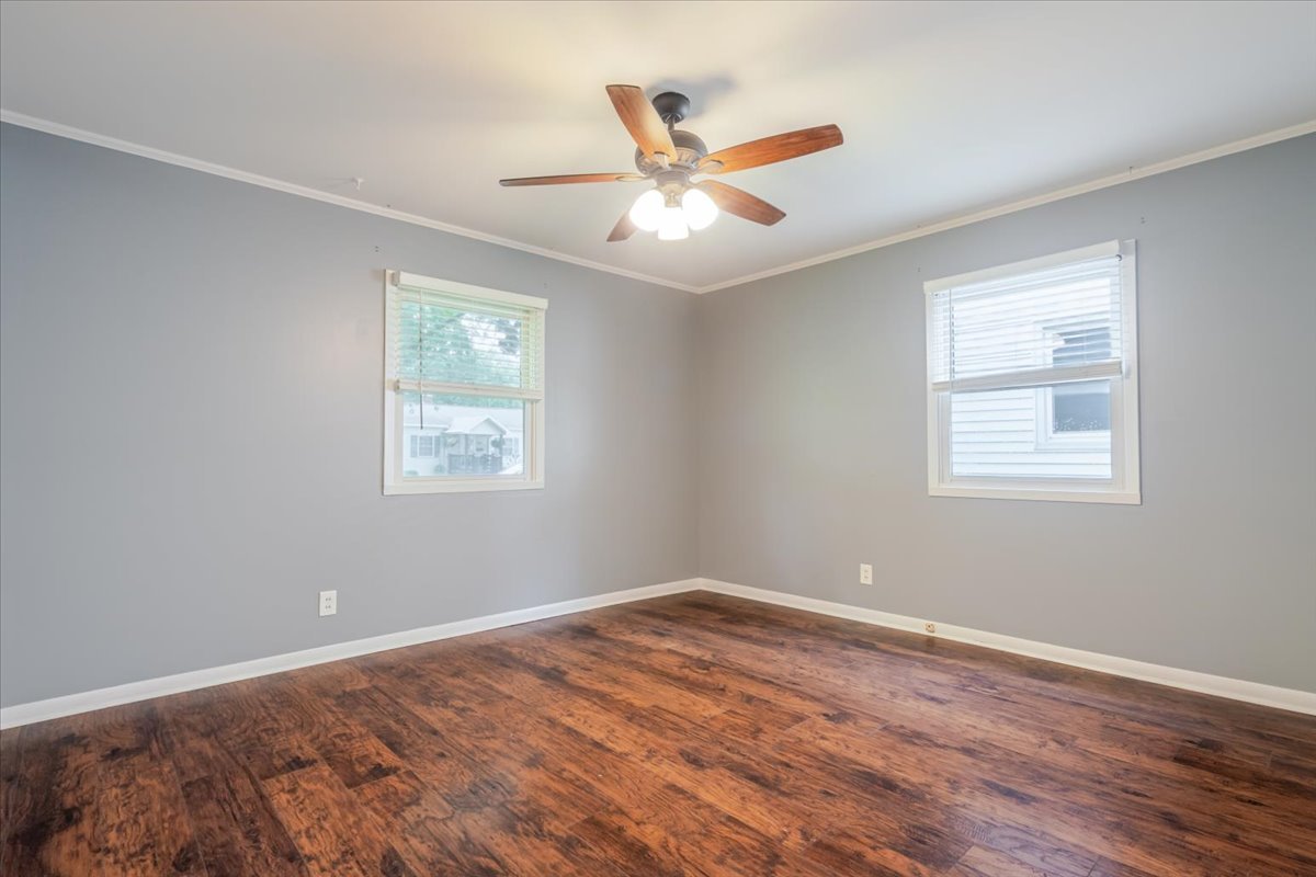 307 Meadows Avenue Bloomington, IL 61701 - Photo 11 of 15 a view of a room with wooden floor and a ceiling fan