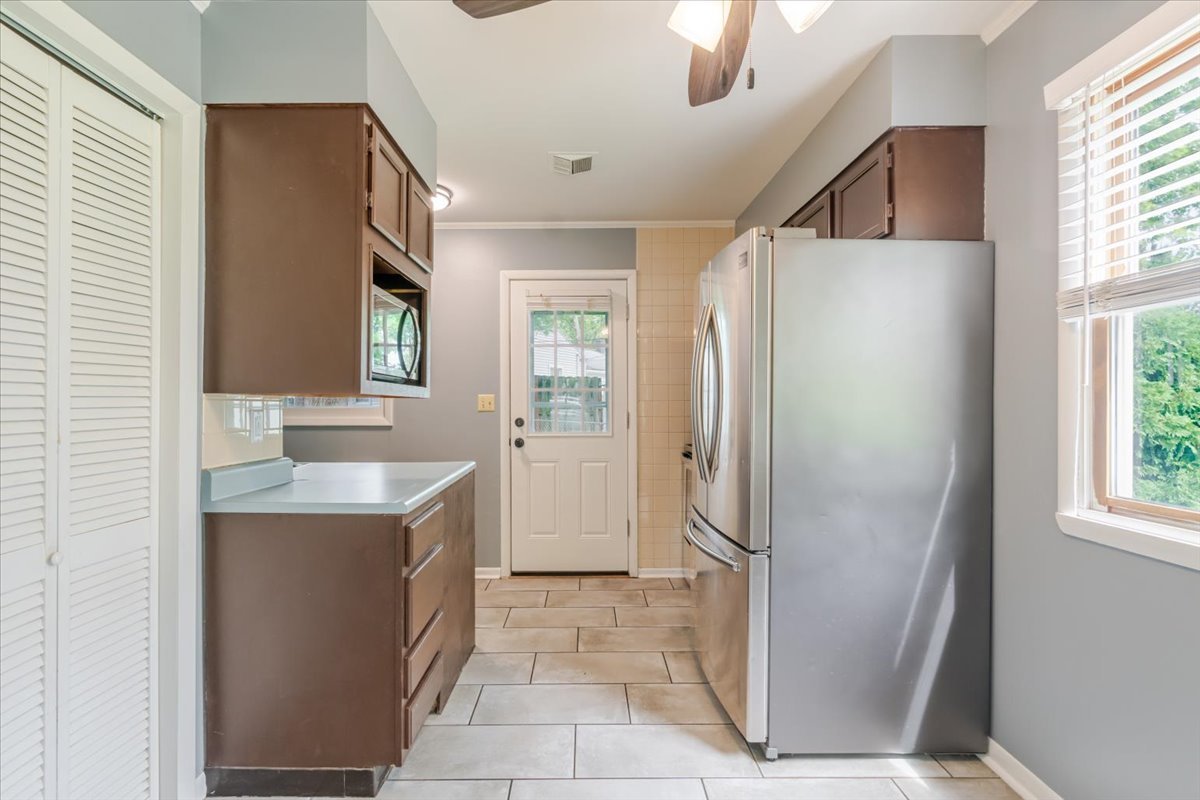 307 Meadows Avenue Bloomington, IL 61701 - Photo 5 of 15 a bathroom with a granite countertop sink a mirror and a shower