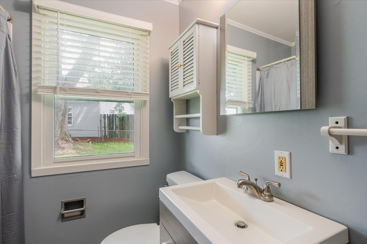 307 Meadows Avenue Bloomington, IL 61701 - Photo 9 of 15 a bathroom with a sink and a mirror