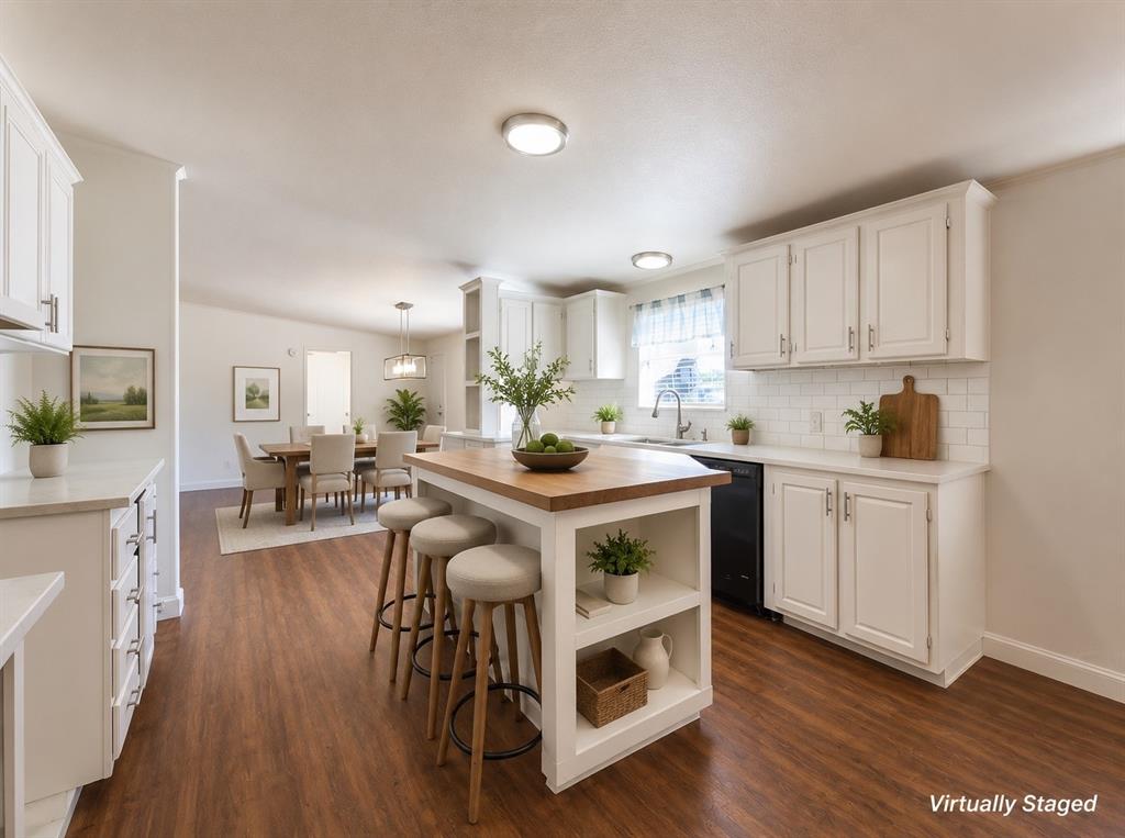 18327 Gholson Road Waco, TX 76705 - Photo 6 of 19 Open-concept kitchen with wood-finish flooring, white cabinetry, a central island with a wood countertop, a white subway tile backsplash, and recessed lighting