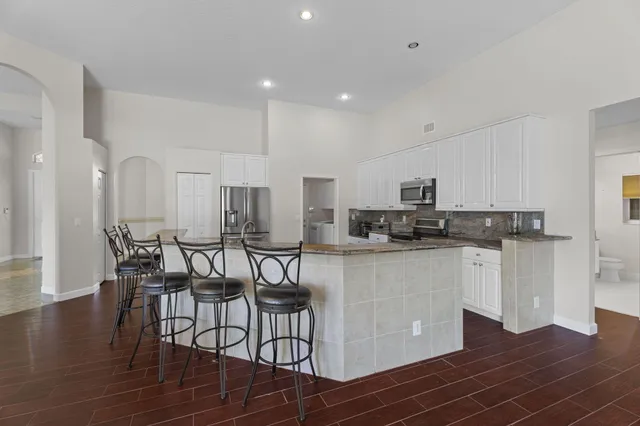 a view of a dining room with furniture wooden floor and chandelier