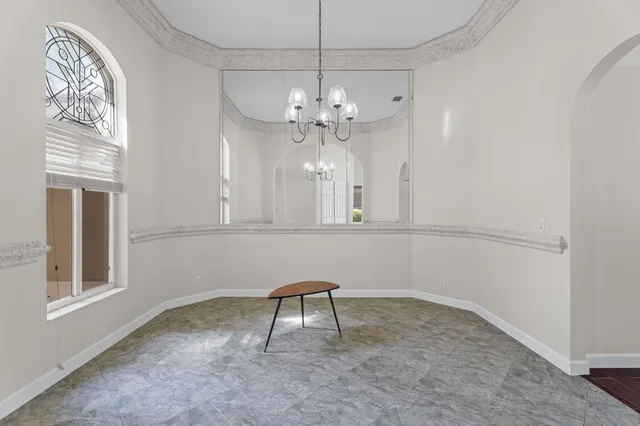 a view of a livingroom with a furniture and chandelier fan