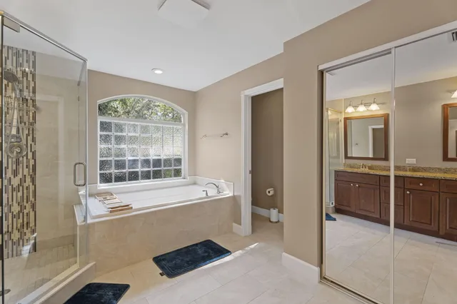 a bathroom with bathtub and window