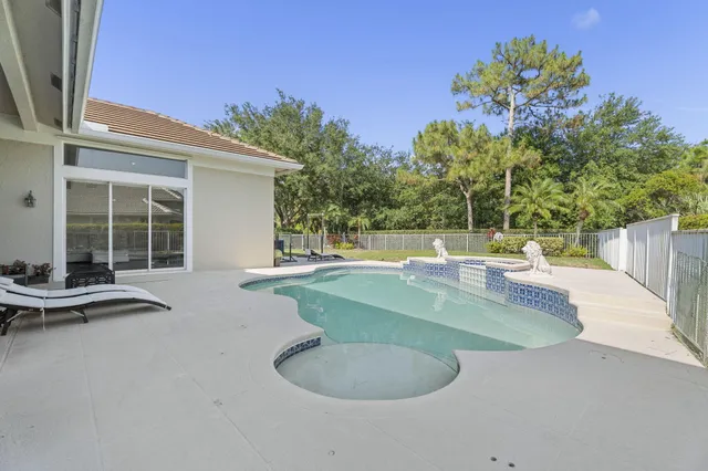 a view of a swimming pool with a table and chairs