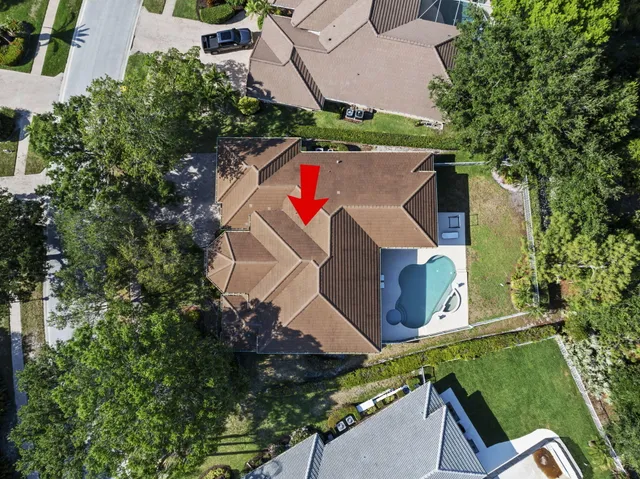an aerial view of residential houses with outdoor space and trees