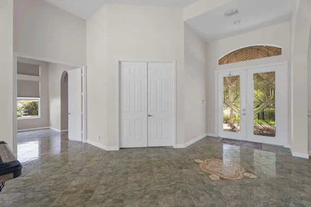 a kitchen with stainless steel appliances kitchen island granite countertop a stove top oven a sink a dining table and chairs with wooden floor