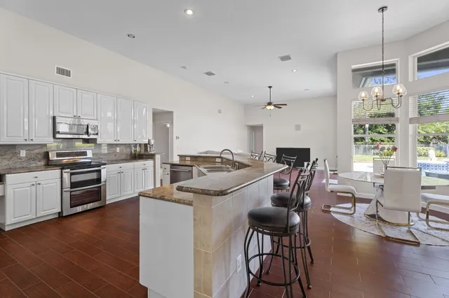 a large kitchen with a lot of counter space and a sink