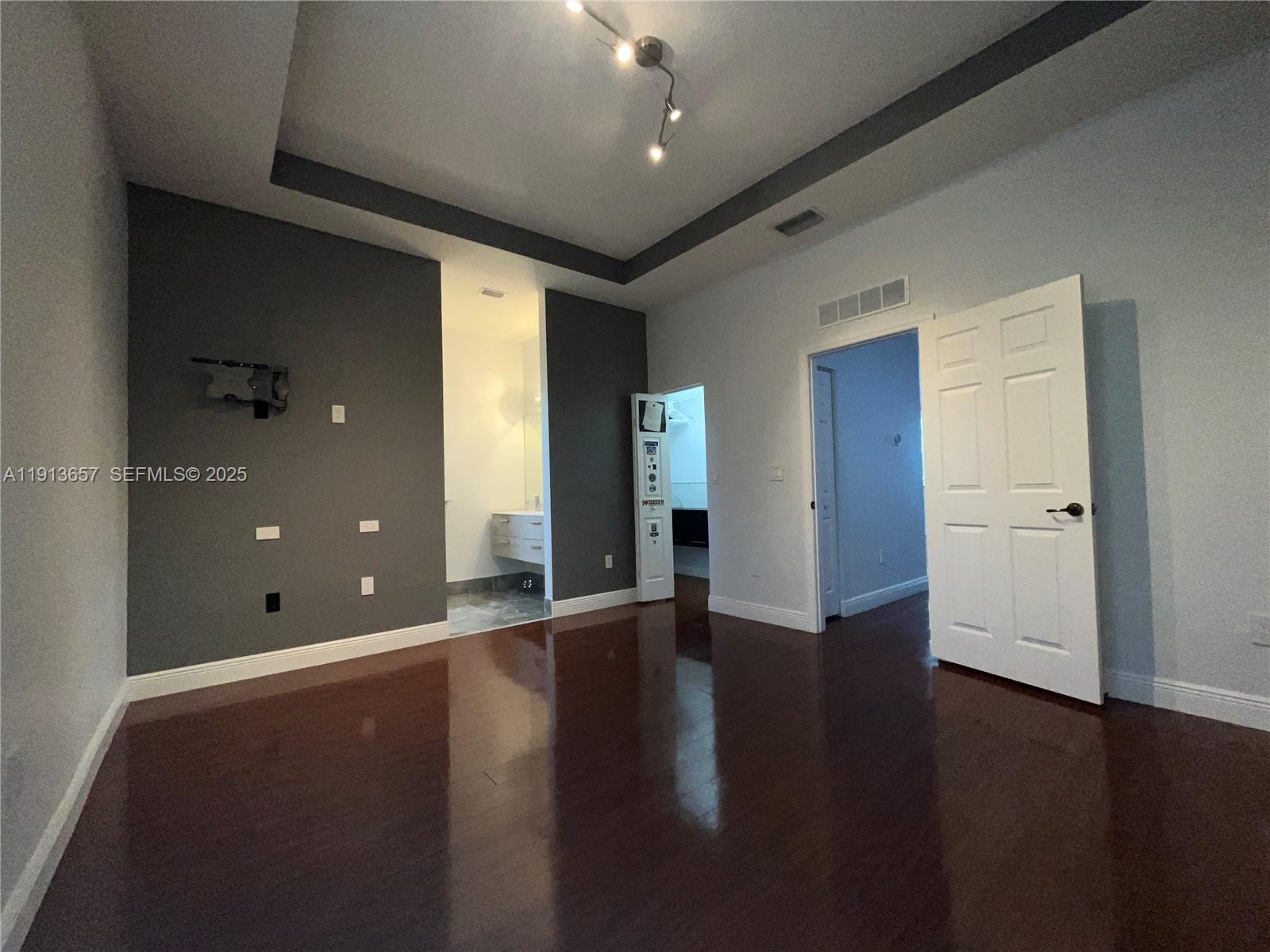 4929 Southwest 140th Terrace, Unit 5 Miramar, FL 33027 - Photo 19 of 43 an empty room with wooden floor and windows