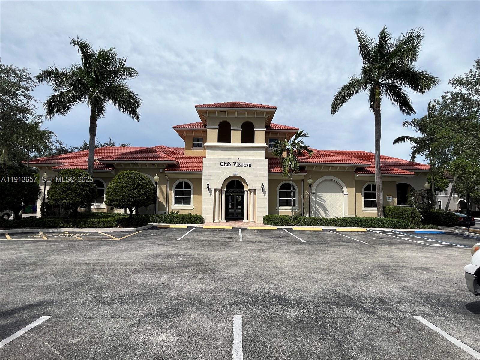 4929 Southwest 140th Terrace, Unit 5 Miramar, FL 33027 - Photo 29 of 43 a front view of a house with a garden and a garage