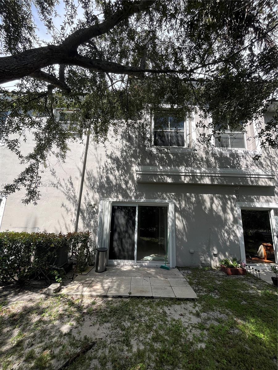 4929 Southwest 140th Terrace, Unit 5 Miramar, FL 33027 - Photo 3 of 43 a front view of a house with a yard