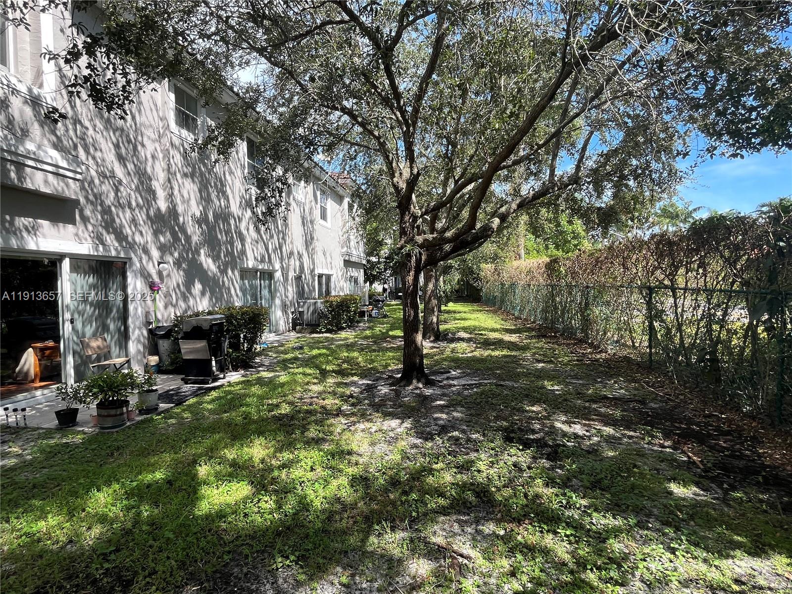 4929 Southwest 140th Terrace, Unit 5 Miramar, FL 33027 - Photo 4 of 43 a row of trees and covered with tall trees