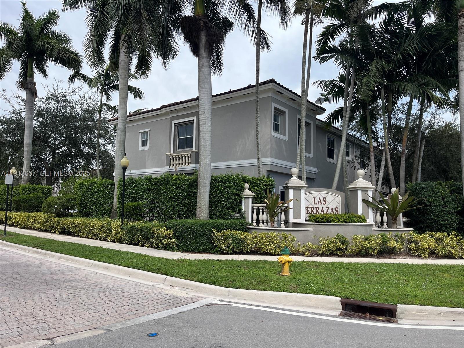 4929 Southwest 140th Terrace, Unit 5 Miramar, FL 33027 - Photo 5 of 43 a front view of a house with a garden and a yard