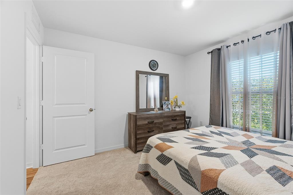 1304 Goshen Road North Port, FL 34288 - Photo 17 of 39 a bedroom with a bed and a large mirror