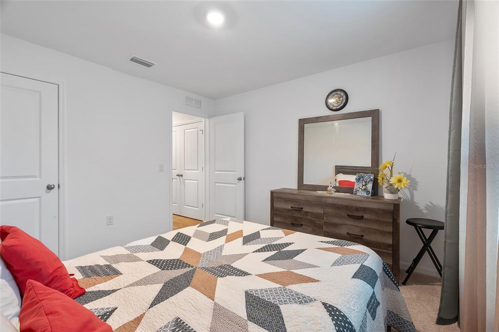 1304 Goshen Road North Port, FL 34288 - Photo 18 of 39 a bedroom with a bed and a mirror on dresser