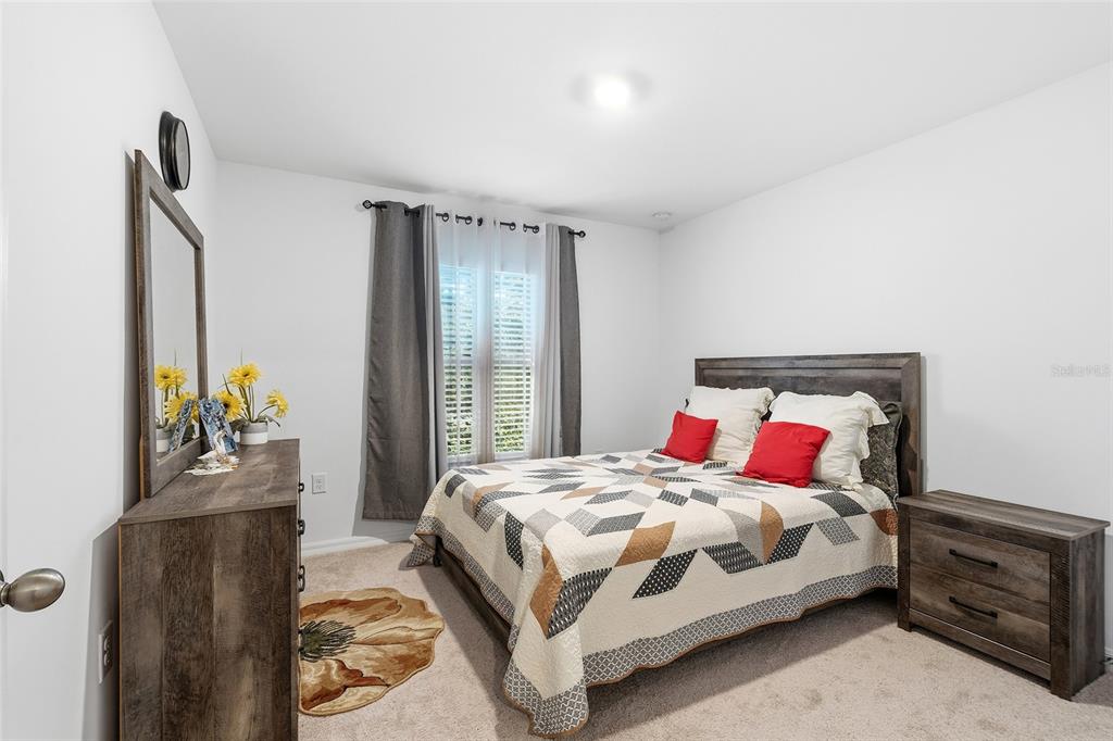 1304 Goshen Road North Port, FL 34288 - Photo 20 of 39 a bedroom with a bed and a dresser