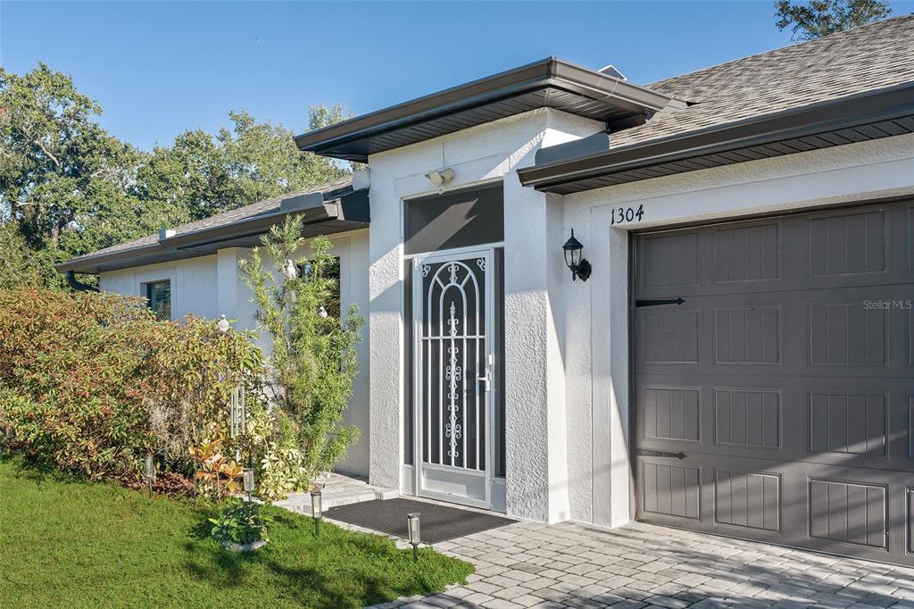 1304 Goshen Road North Port, FL 34288 - Photo 2 of 39 a front view of a house with garden