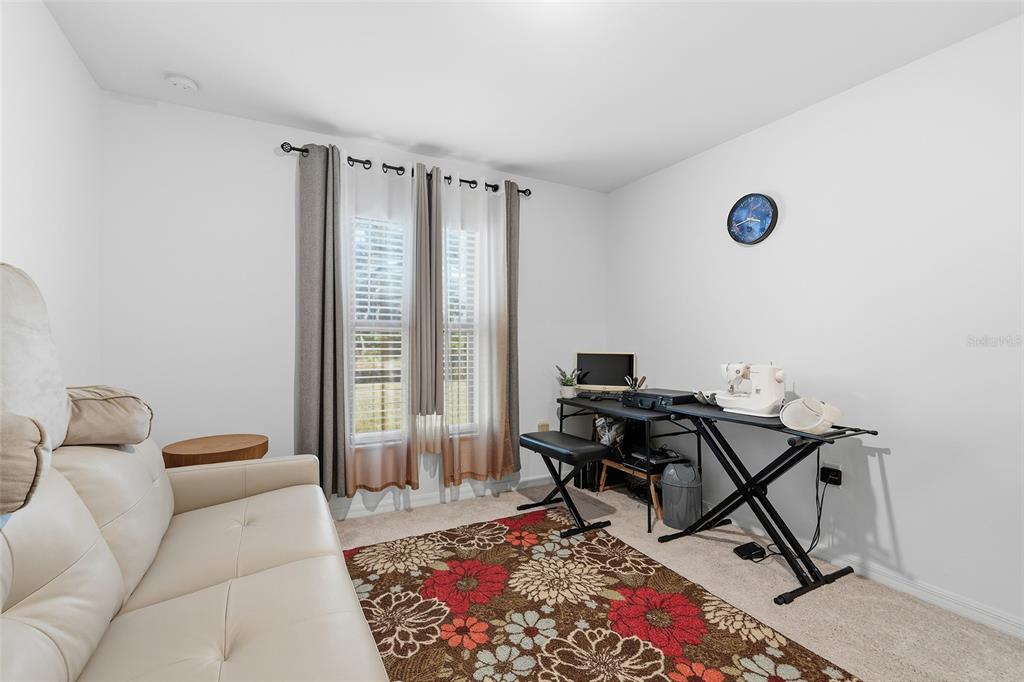 1304 Goshen Road North Port, FL 34288 - Photo 21 of 39 a bedroom with a bed and a desk