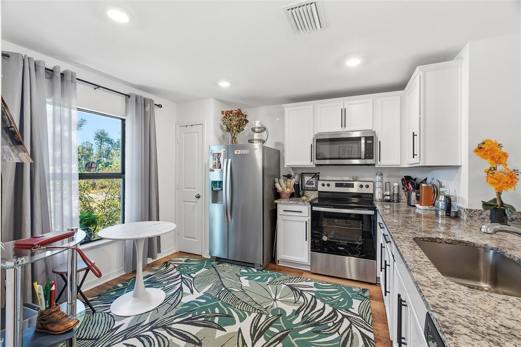 1304 Goshen Road North Port, FL 34288 - Photo 4 of 39 a kitchen with stainless steel appliances granite countertop a refrigerator sink and stove