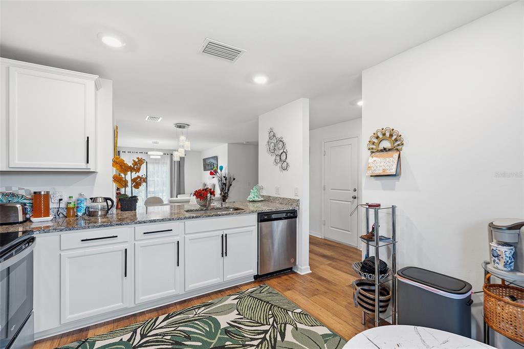 1304 Goshen Road North Port, FL 34288 - Photo 5 of 39 a kitchen with stainless steel appliances kitchen island granite countertop a sink and cabinets