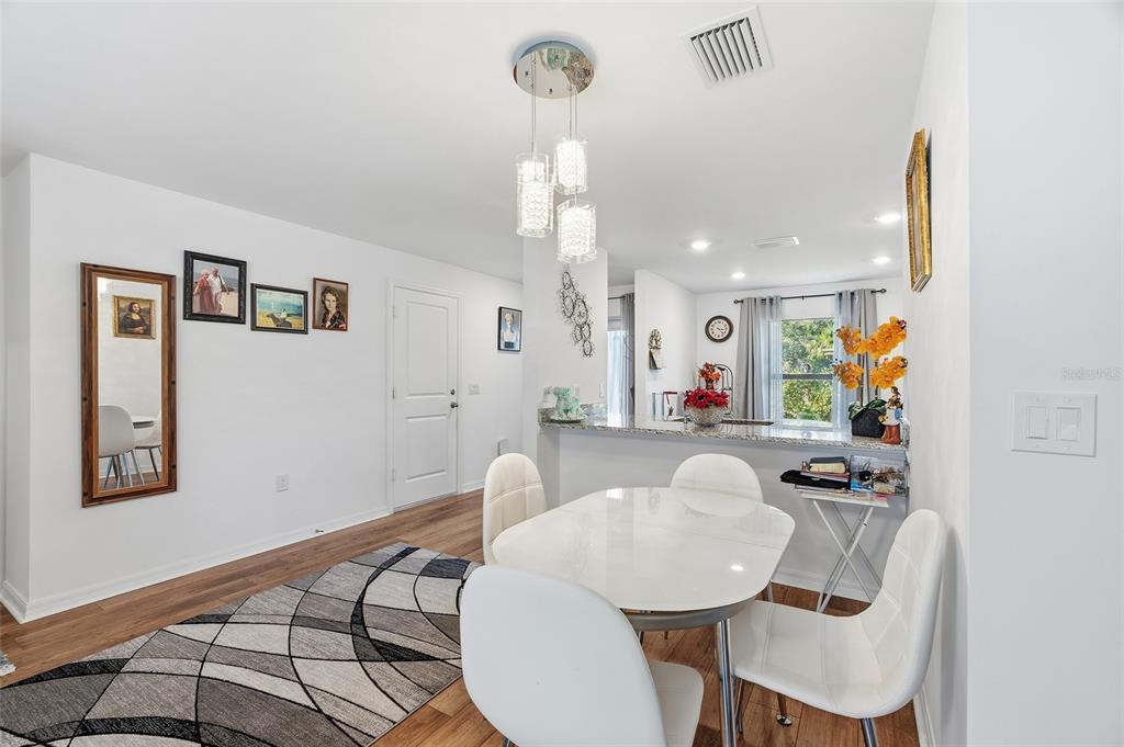 1304 Goshen Road North Port, FL 34288 - Photo 6 of 39 a view of a dining room with furniture and wooden floor