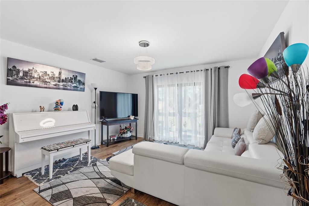 1304 Goshen Road North Port, FL 34288 - Photo 7 of 39 a living room with furniture and a flat screen tv