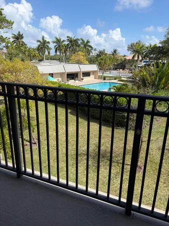 a palm tree sitting in front of a house with a yard