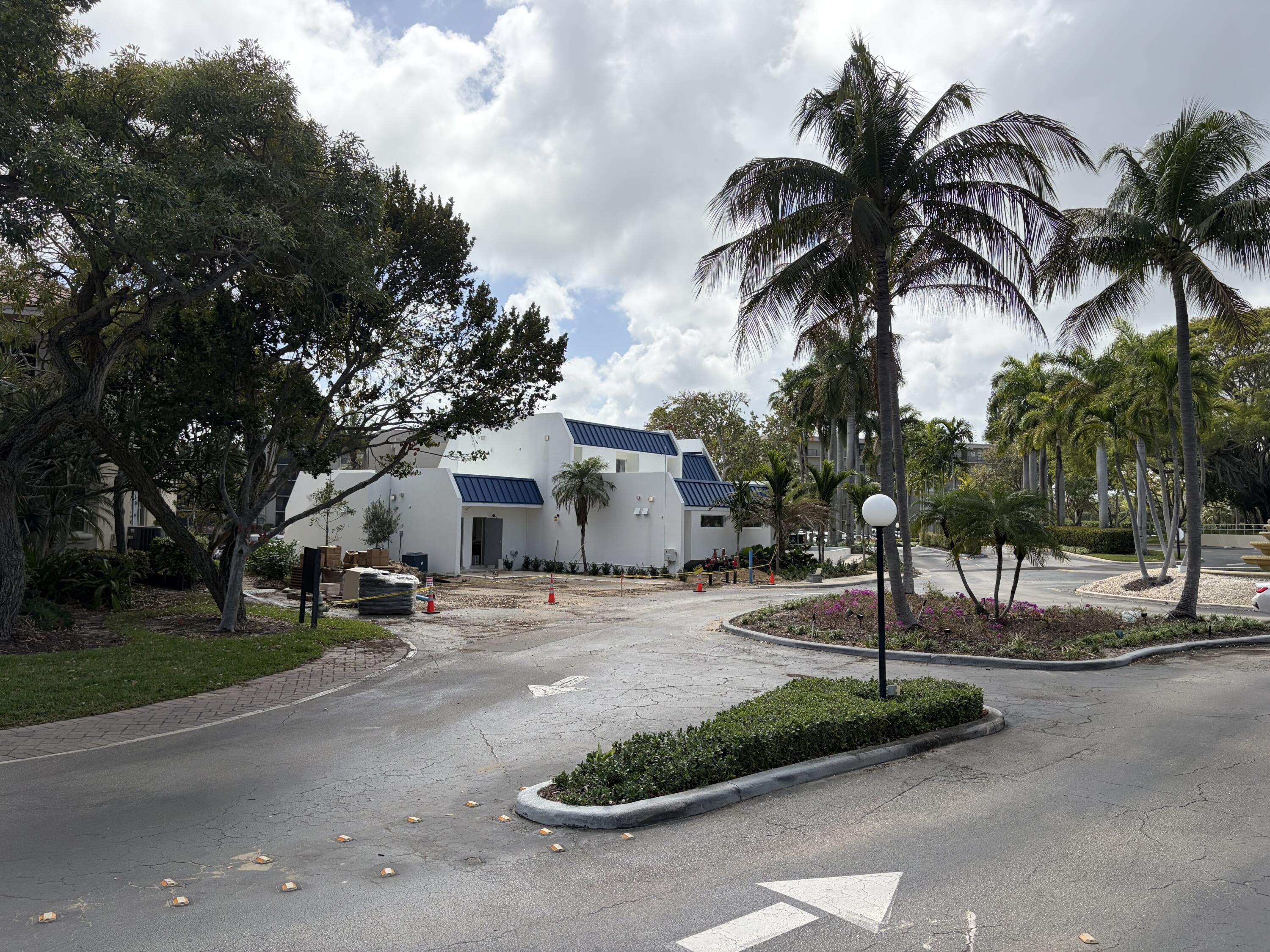 27 Royal Palm Way, Unit 304 Boca Raton, FL 33432 - Photo 23 of 26 a palm tree sitting in front of a house with a yard