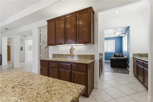 a en suite bathroom with a granite countertop sink and a mirror