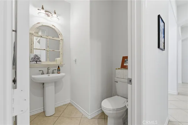 a bathroom with a sink toilet and a mirror