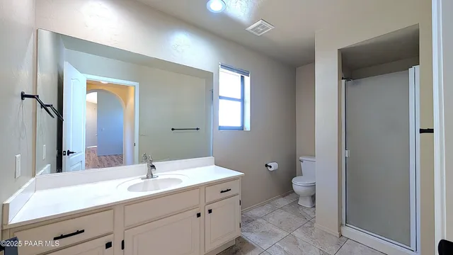 a bathroom with a double vanity sink toilet and a mirror