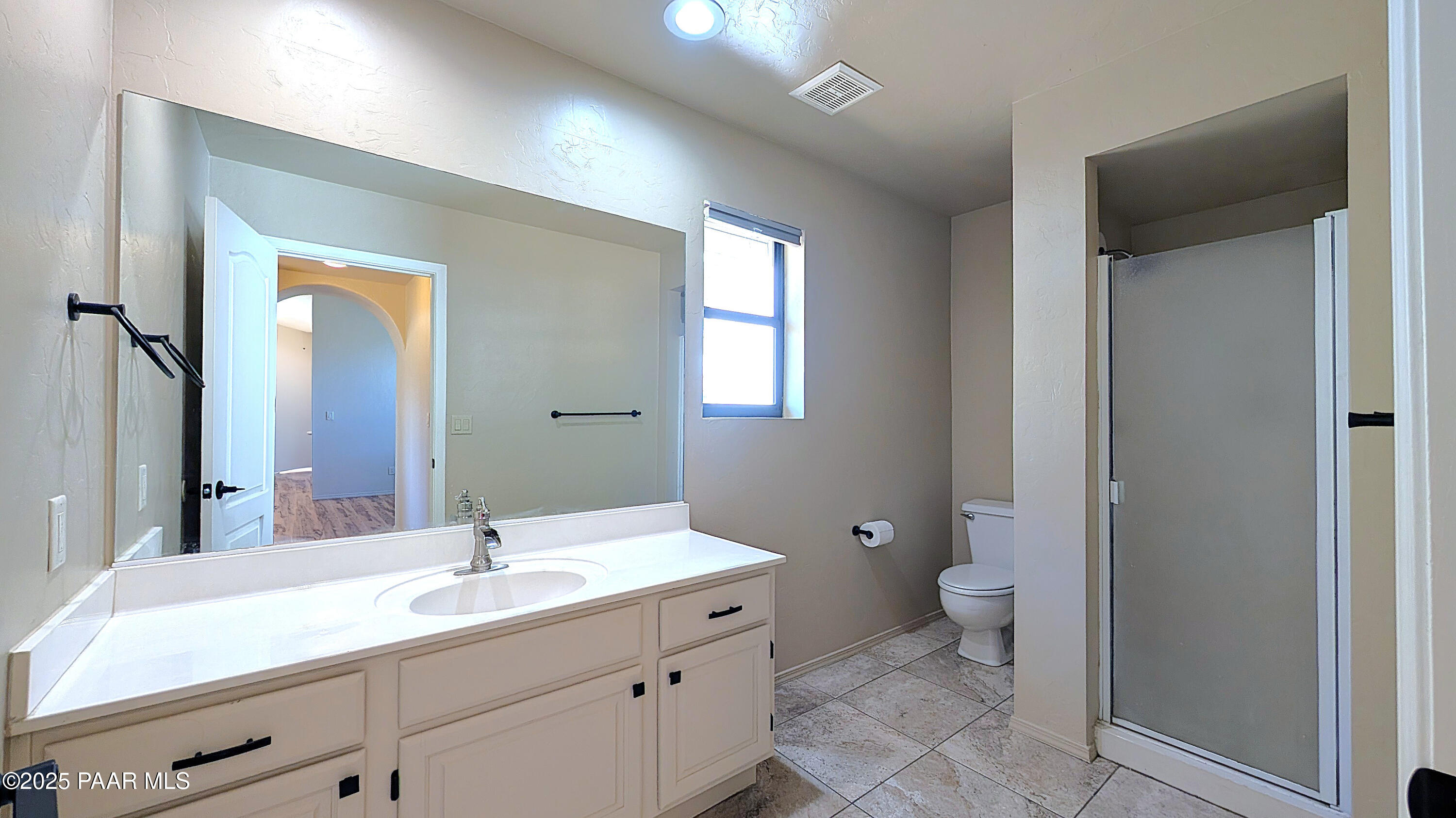 4911 Hornet Drive Prescott, AZ 86301 - Photo 17 of 29 a bathroom with a double vanity sink toilet and a mirror