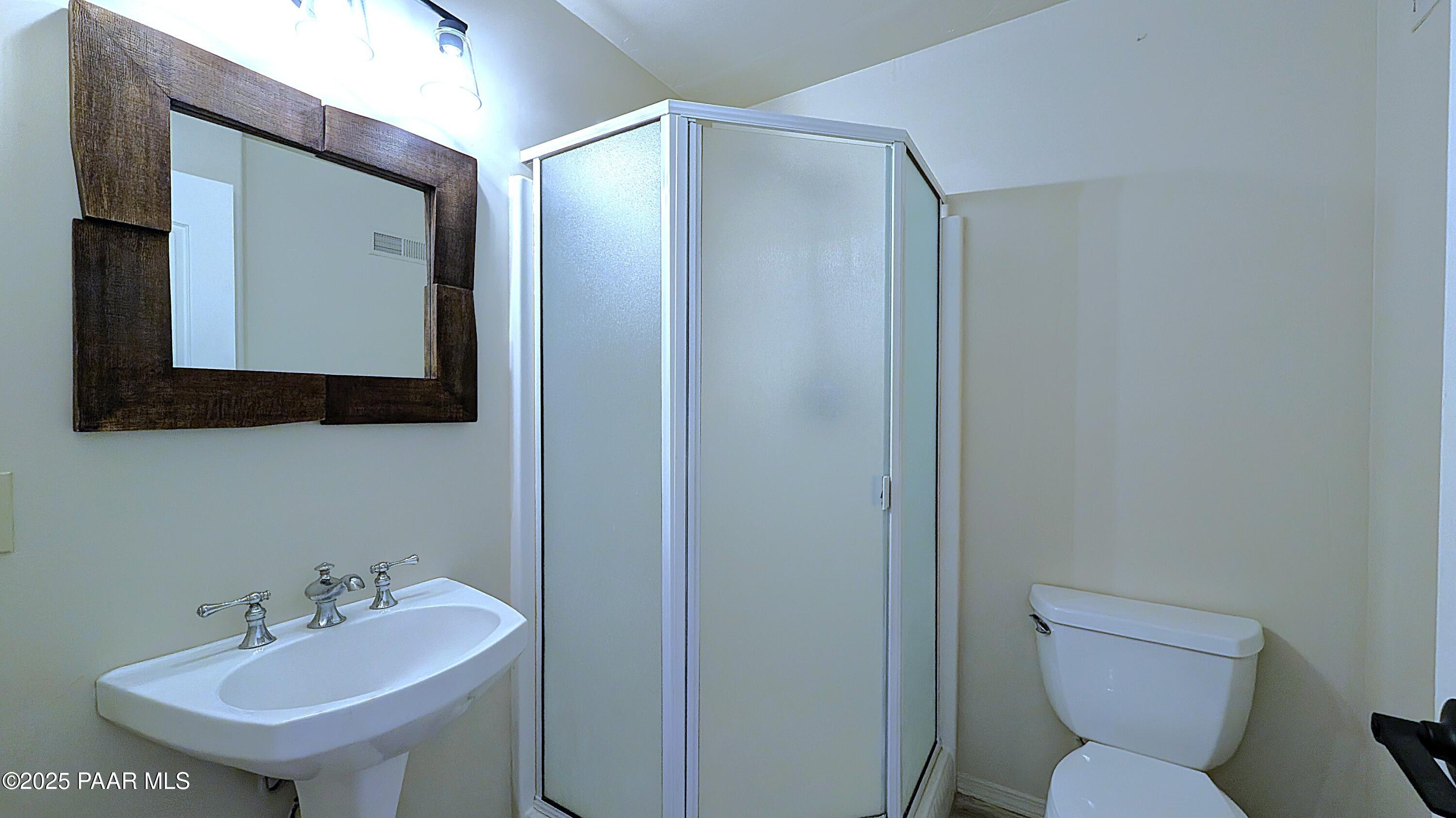 4911 Hornet Drive Prescott, AZ 86301 - Photo 24 of 29 a bathroom with a toilet sink and mirror