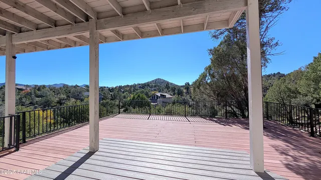 a wooden deck with sunset view