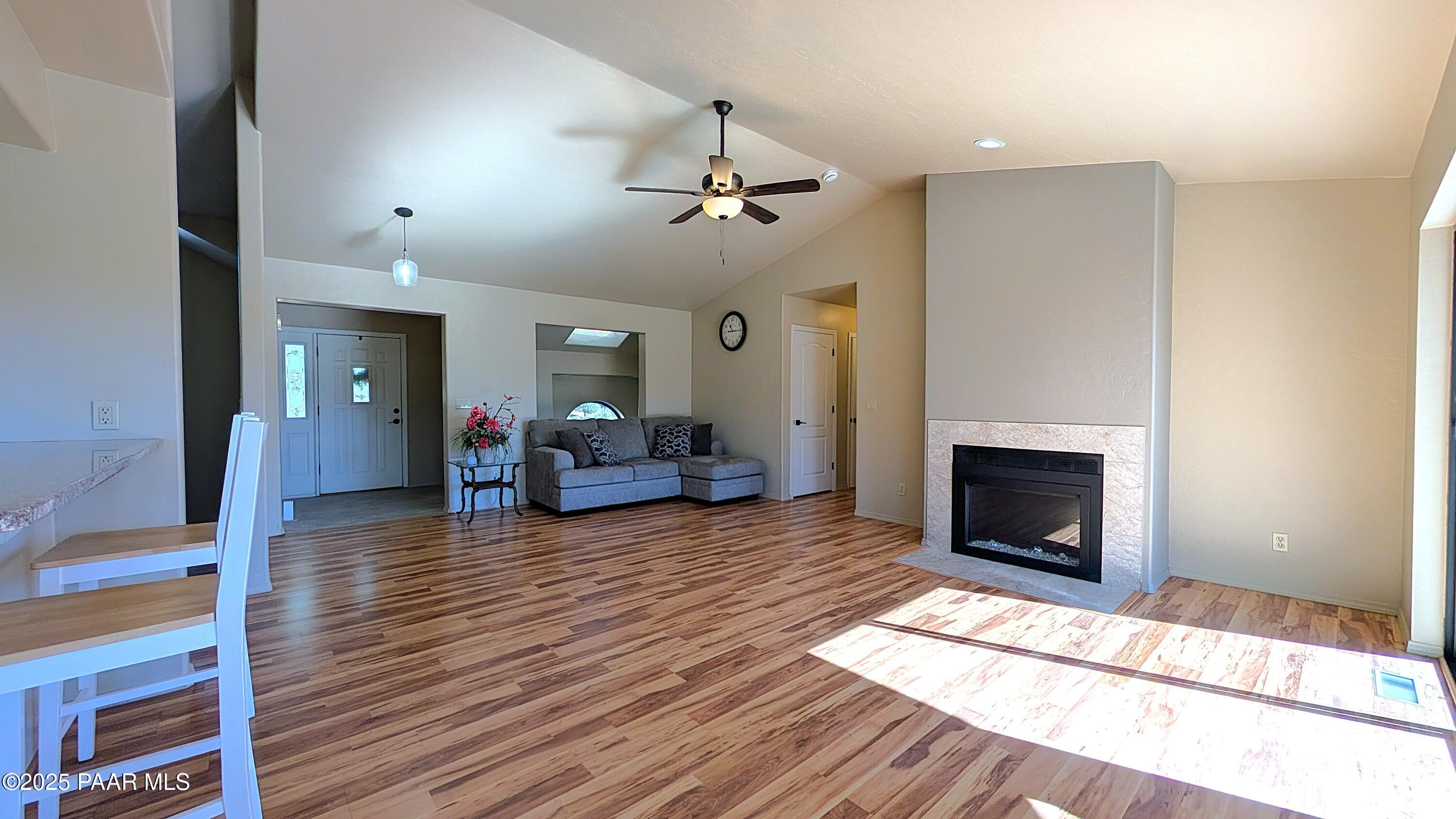 4911 Hornet Drive Prescott, AZ 86301 - Photo 6 of 29 a living room with furniture a fireplace and wooden floor