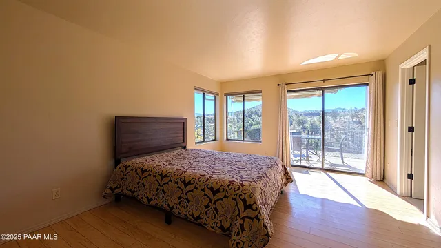 a bedroom with a bed and a large window