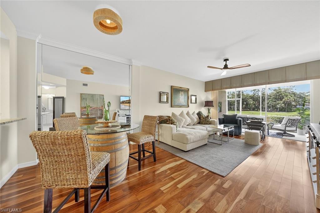 1940 Willow Bend Circle, Unit 102 Naples, FL 34109 - Photo 1 of 39 a living room with furniture and a large window