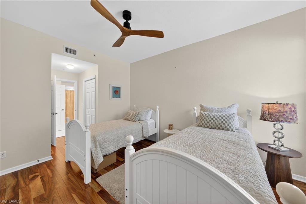1940 Willow Bend Circle, Unit 102 Naples, FL 34109 - Photo 15 of 39 a bedroom with two beds and painting on the wall
