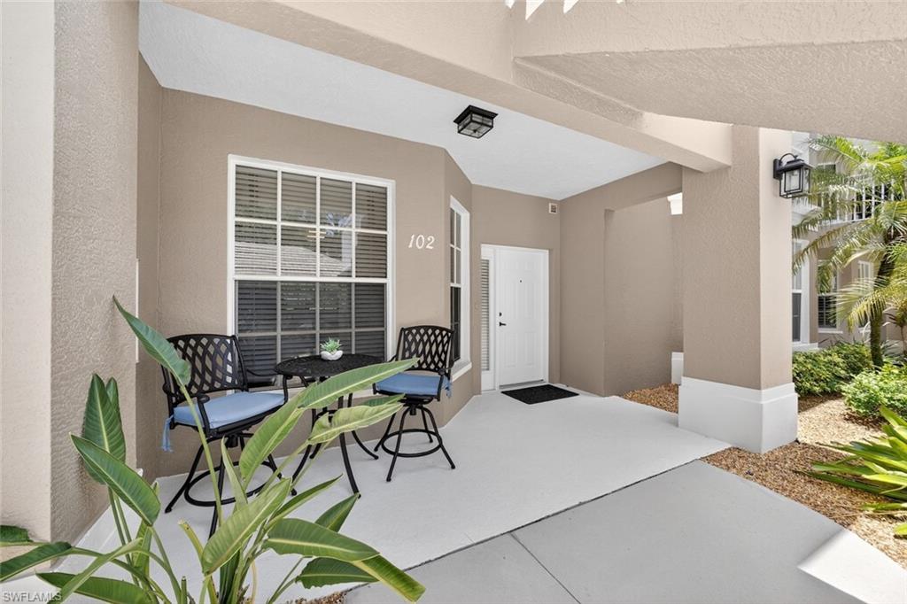 1940 Willow Bend Circle, Unit 102 Naples, FL 34109 - Photo 23 of 39 a living room with furniture and a potted plant