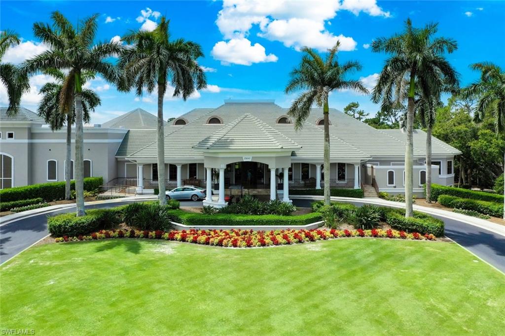 1940 Willow Bend Circle, Unit 102 Naples, FL 34109 - Photo 32 of 39 a front view of house with yard and outdoor seating