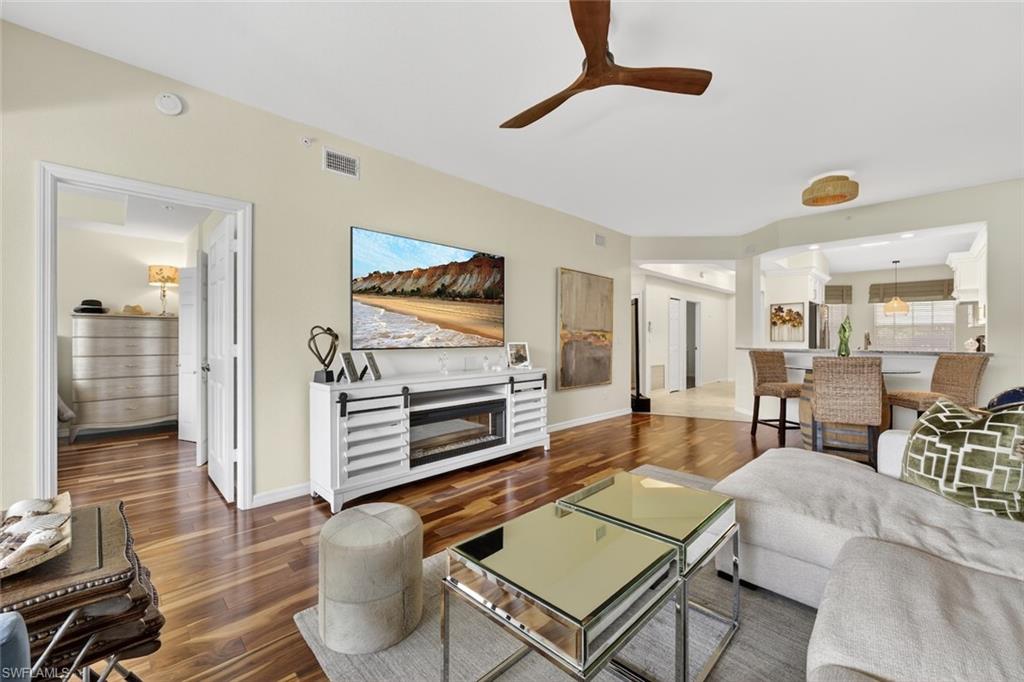 1940 Willow Bend Circle, Unit 102 Naples, FL 34109 - Photo 6 of 39 a living room with furniture and a wooden floor